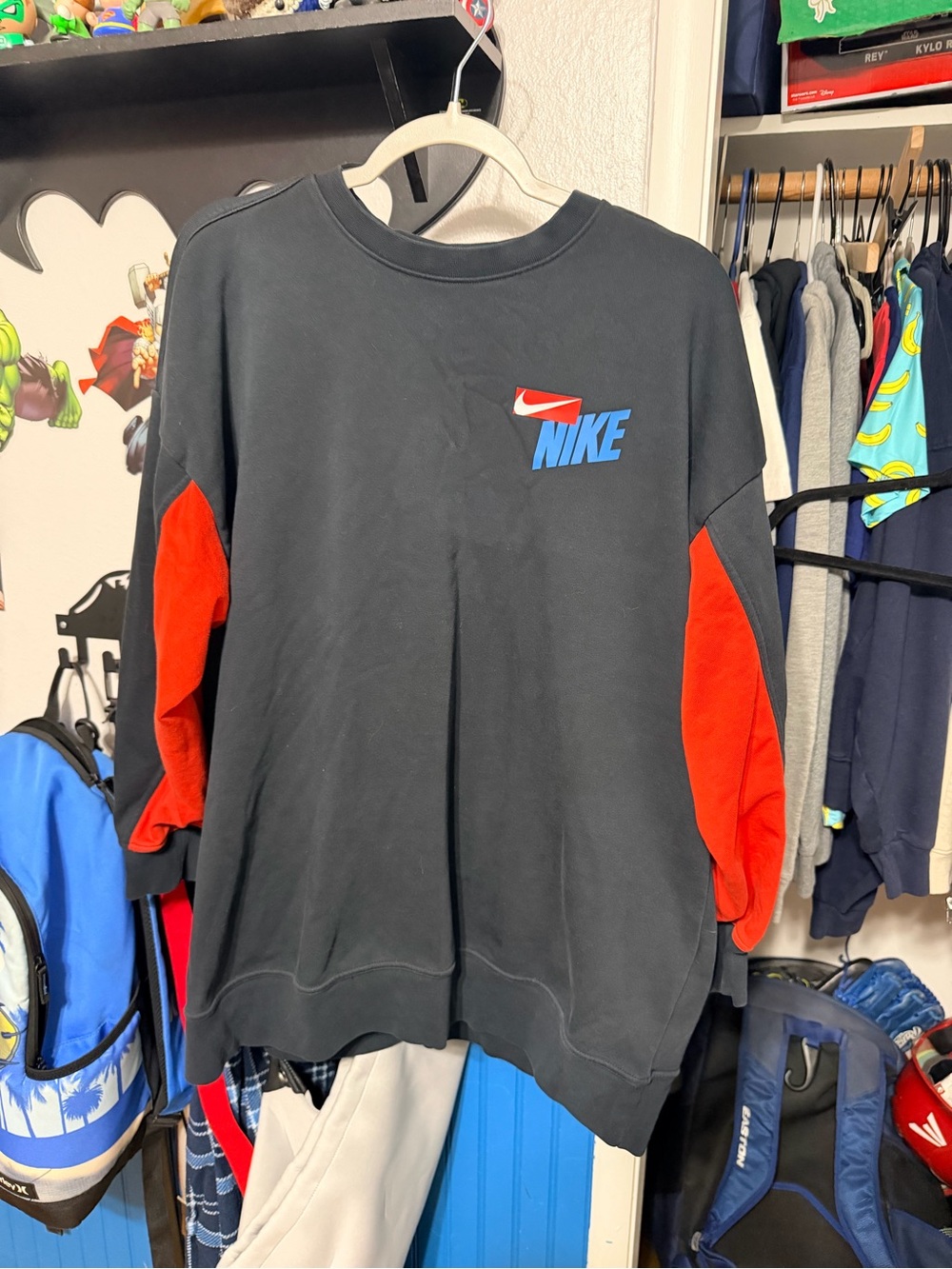Nike Black Crewneck Sweatshirt with Red Sleeve Panels and Blue Logo